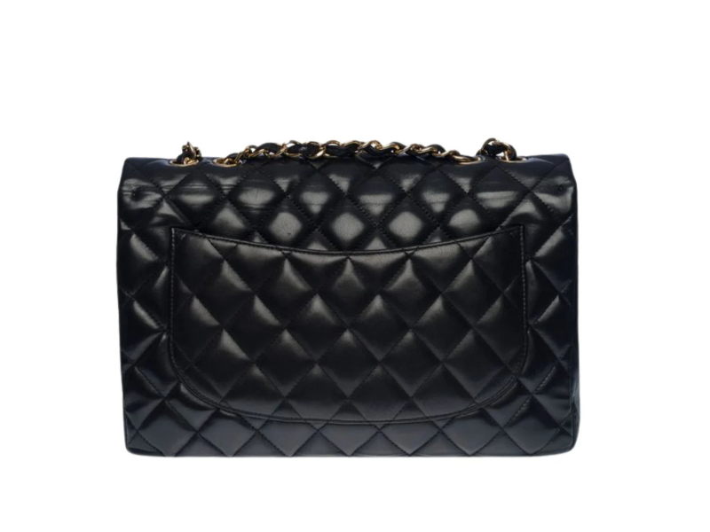 Chanel Classic Jumbo flap bag in black lambskin leather with quilted design and gold-tone hardware.