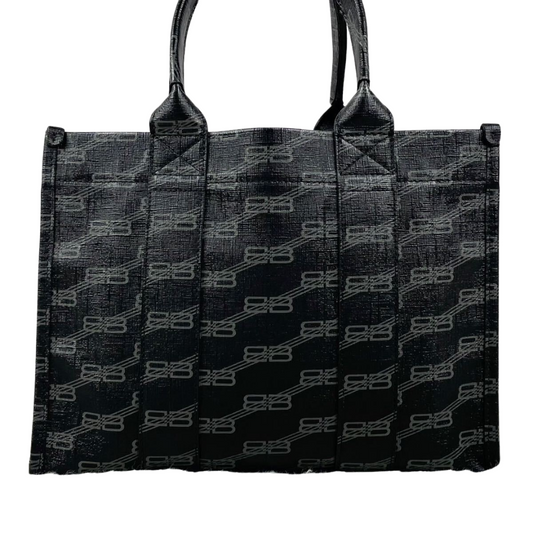 Sideprofil af Balenciaga 2‑Way Tote i sort coated canvas, detalje af form