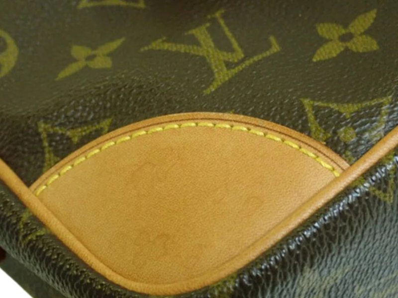 Detail of Louis Vuitton Trocadero 27 showcasing the monogram canvas and Vachetta leather trim.