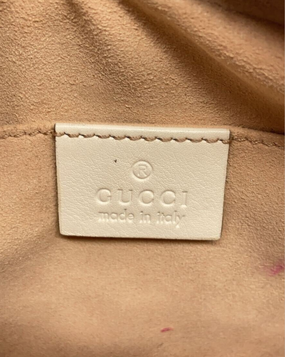 Gucci label made in Italy on the interior of Mini Gucci Marmont Camera Taske in off-white.